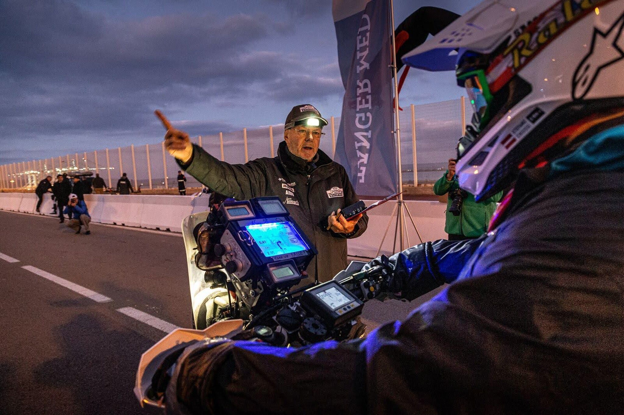 Pilot on motorbike at sunrise with radbook turned on